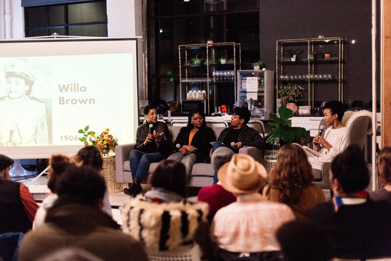 Group of Black women sitting on a couch speaking at a Black Her Stories event