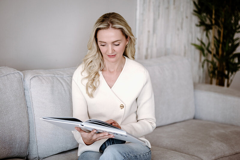 Candid picture of a women sat on the sofa reading a book
