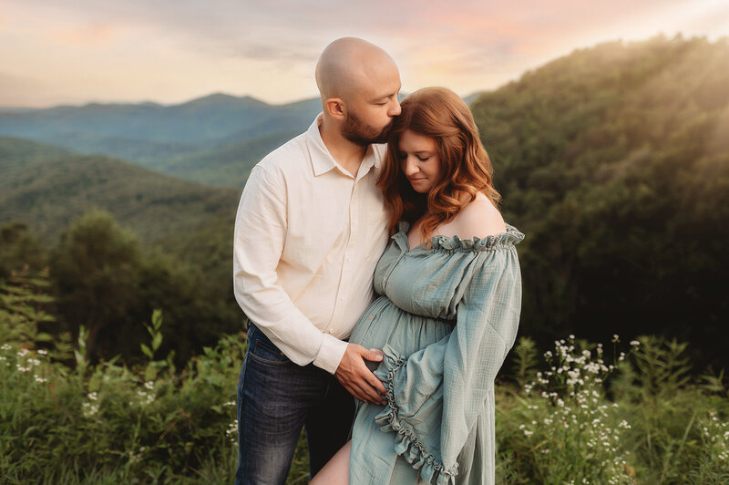 Family Poses with their Infant during Newborn Photoshoot in Asheville, NC.
