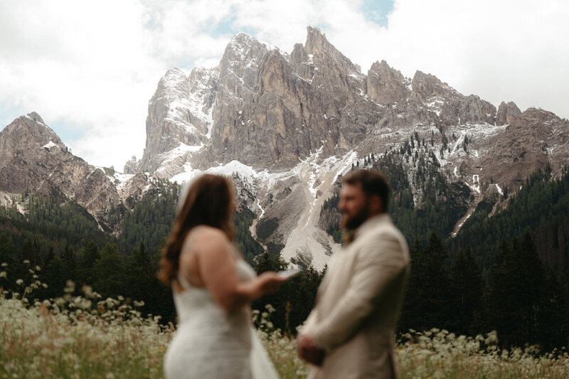 Joyful couple runs along the beach smiling after their Olympic National Park Wedding.