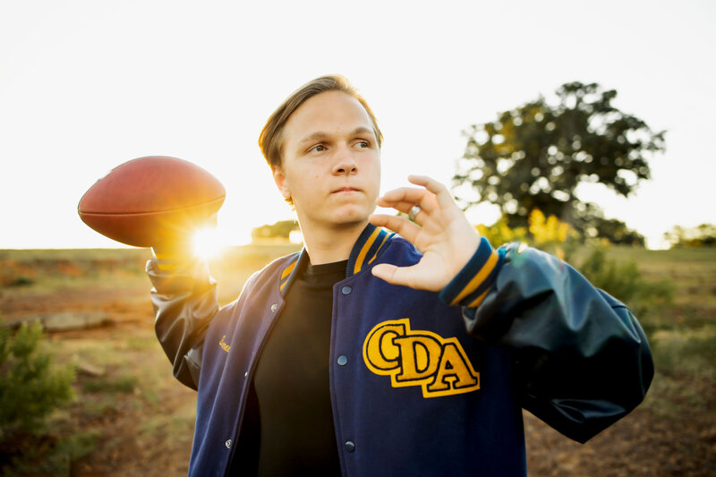 senior boy from Coram Deo Academy poses with football