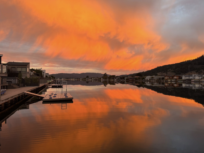 photo taken at sunset of water and floating dock