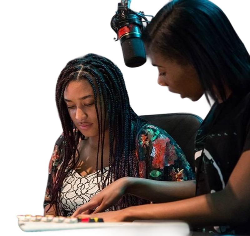 Woman helping young woman in the recording studio
