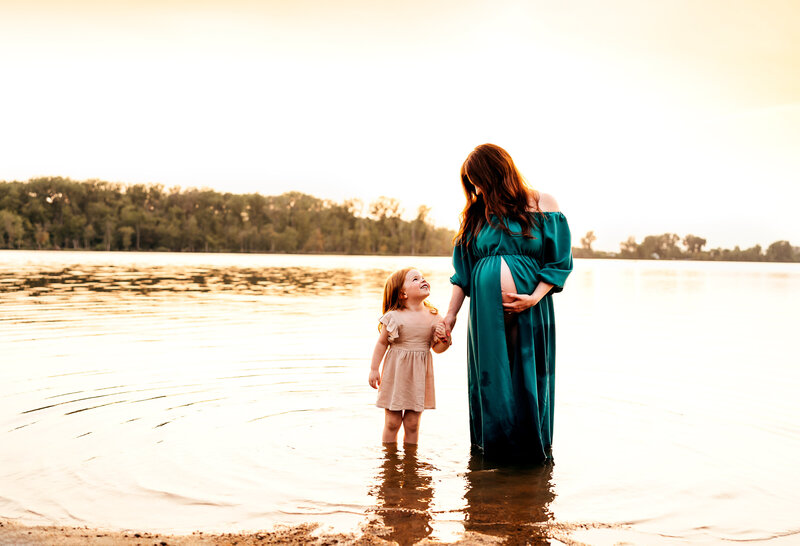 mom and daughter standing in a lake