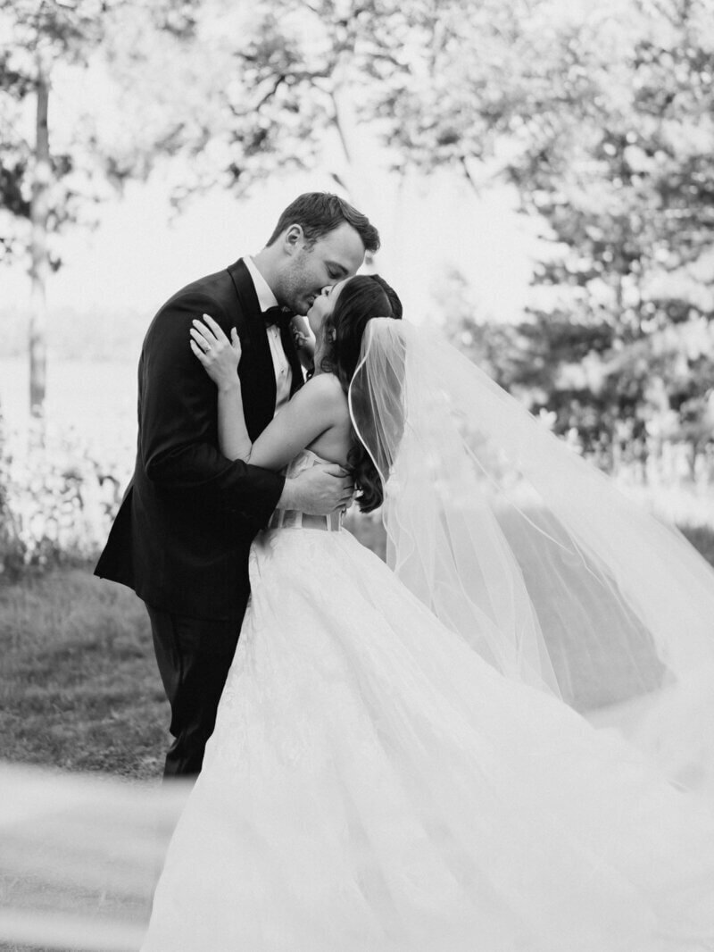 bride and groom kissing at wedding planned by wedding planner minneapolis