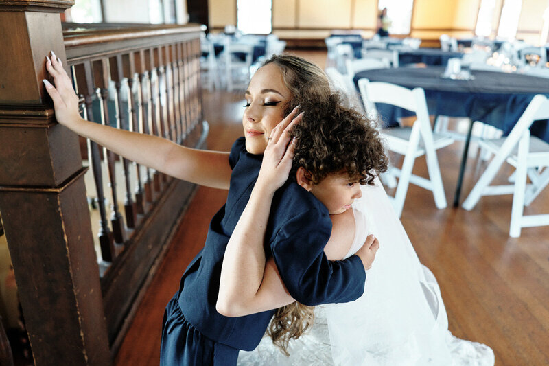Bride hugs her young stepson