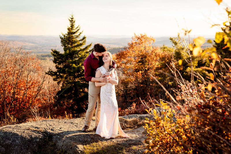 Romantic fall engagement photo in the mountains of New Hampshire. Warm golden light, colorful foliage, and genuine connection captured beautifully.