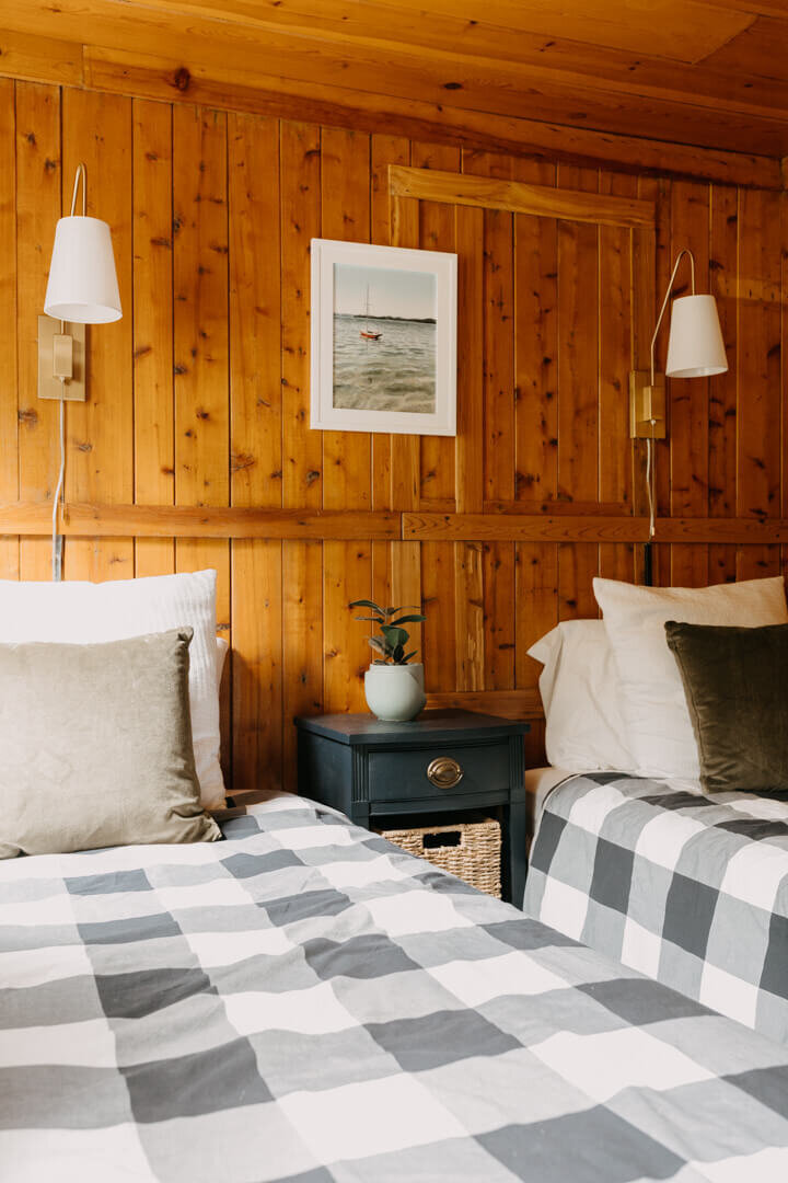 Two beds in guest room with cedar wall