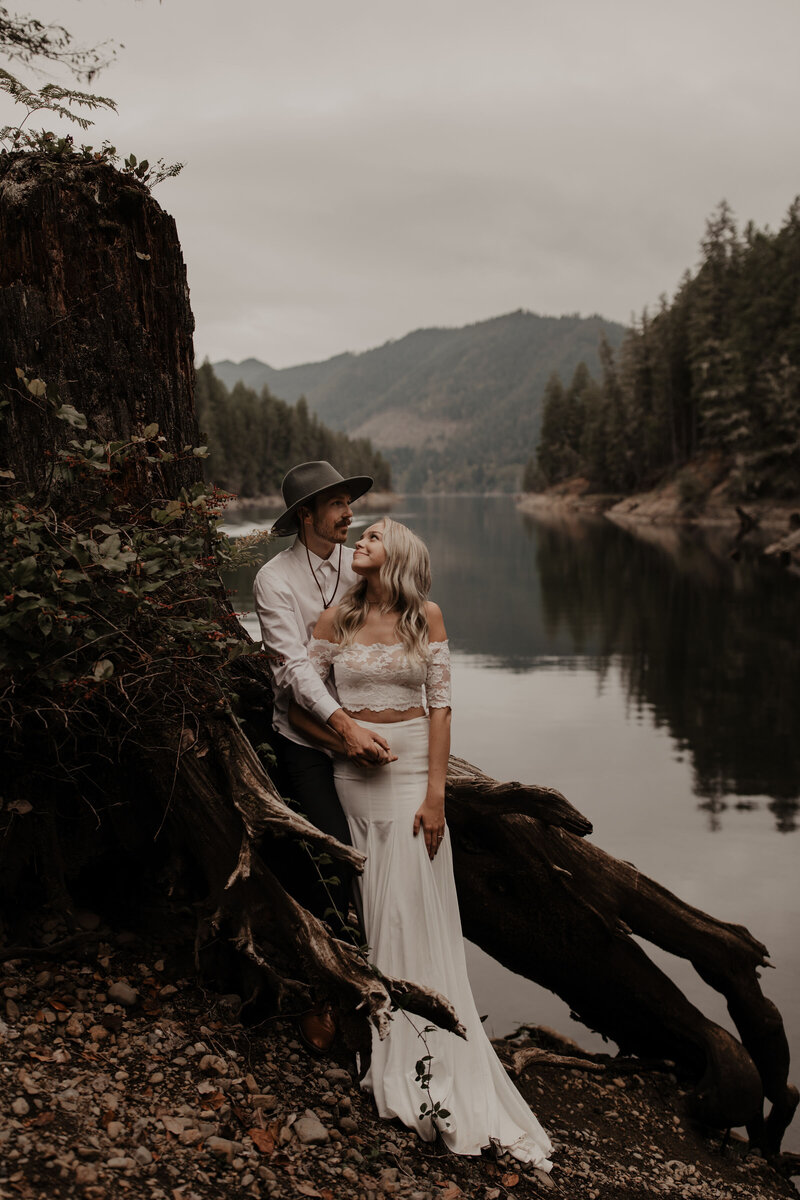 bride and groom eloping next to lake