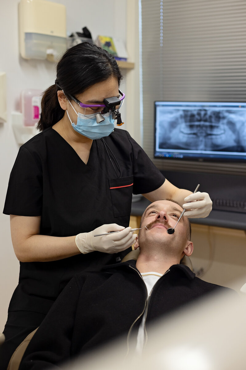 dentist performing a procedure on a happy, comfortable patient