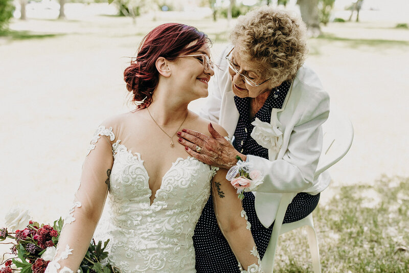 bride and grandmother smiling at each other