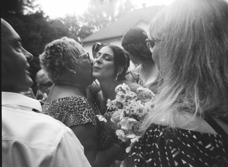 bridal embraces mother after emotional wedding ceremony at private estate in a vintage couture designer wedding gown