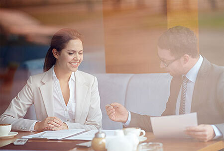Therapist happily working with her CPA in a business meeting.