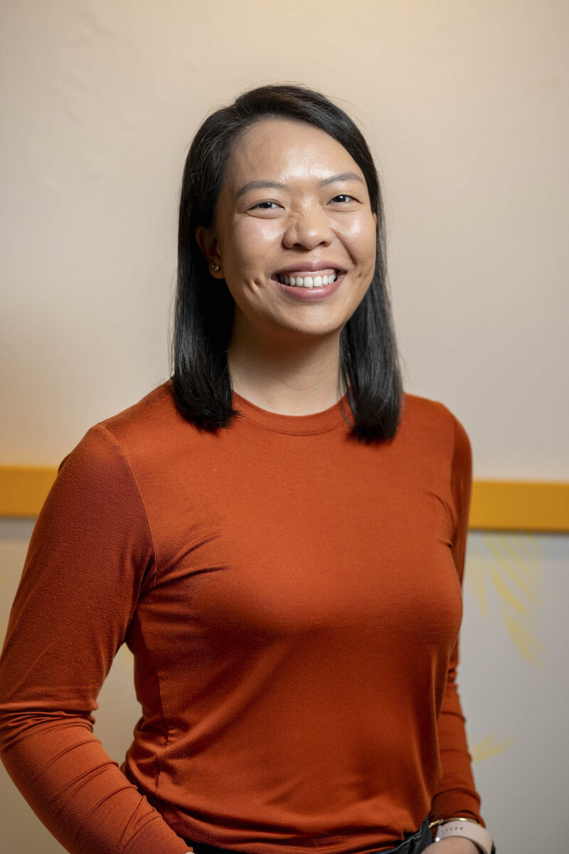 Amy Luong in red long sleeved shirt