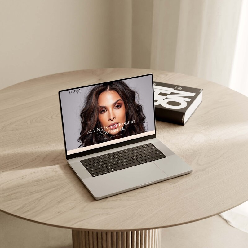 MacBook with open website in browser on a desk