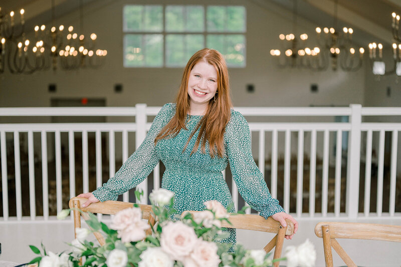 Kaitie Gill in front of a wedding tablescape at The Grandeur House