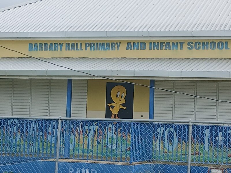 Front gate of Barbary Hall Primary and Infant School showing the school sign.