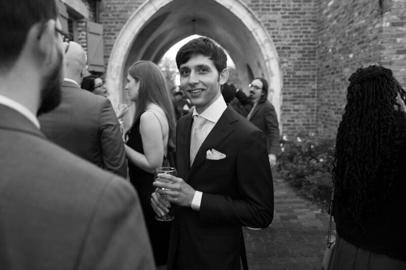 Groom with drink in hand by best film wedding photographers Noble Photo Co