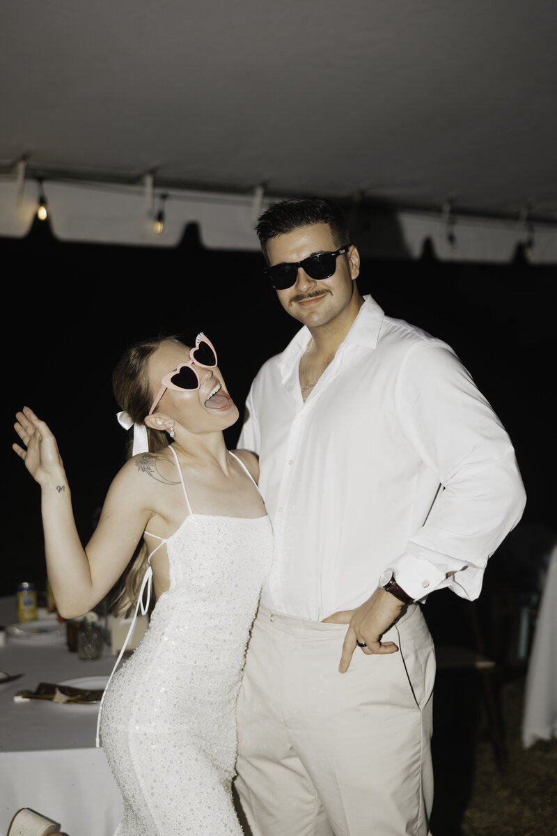 texas couple pose in a field together during their senior photoshoot
