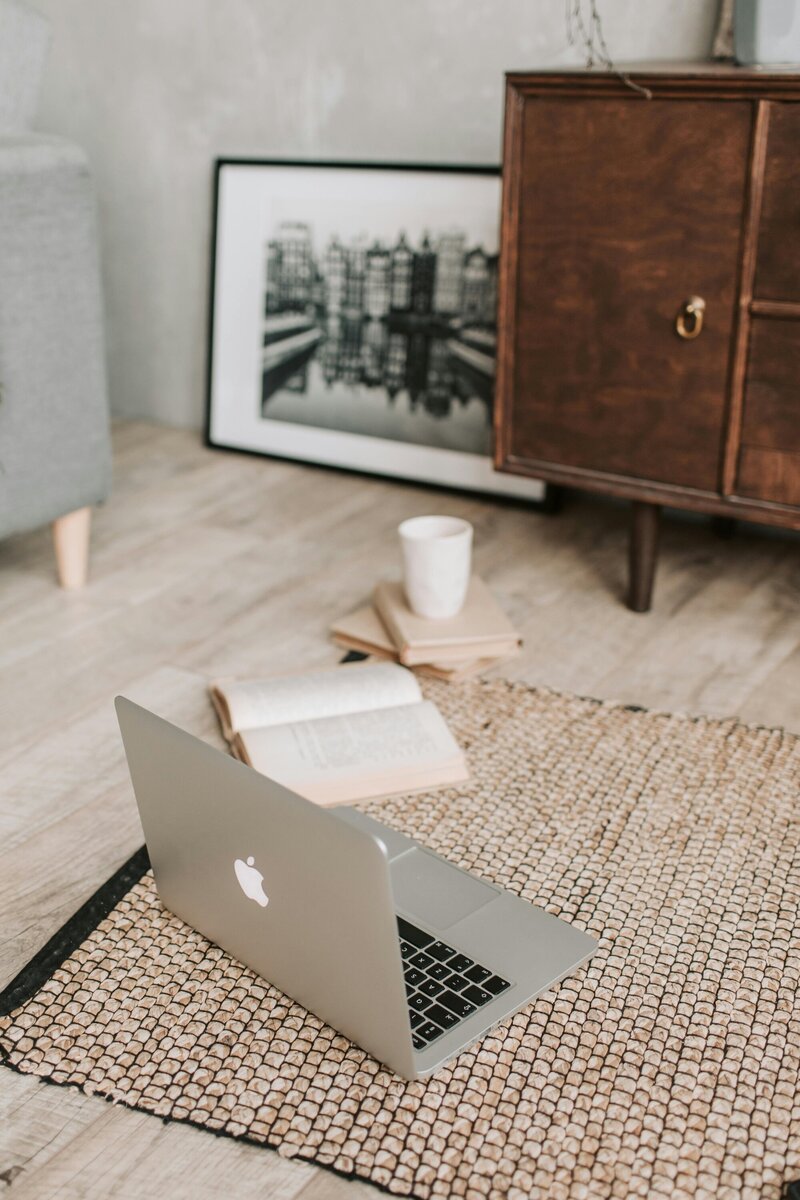 Laptop on a carpet ready to login to the virtual  co-working  session for artists