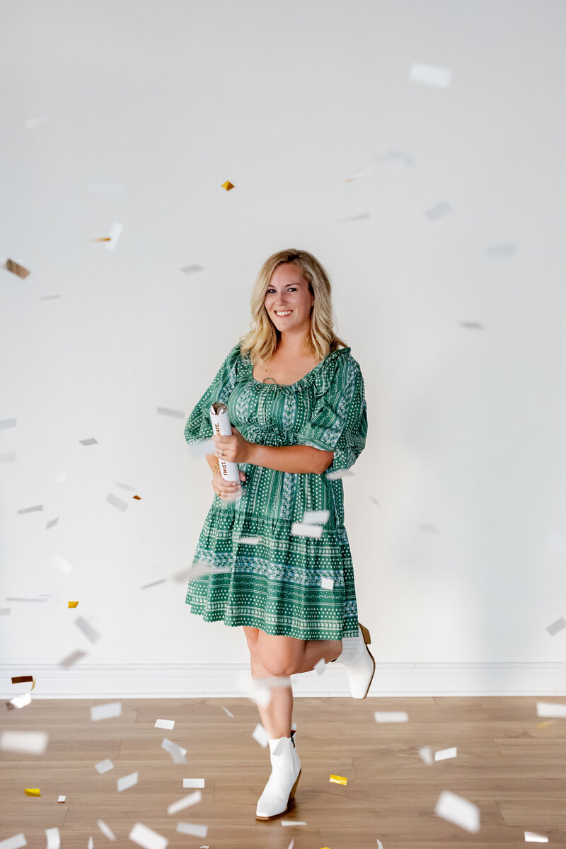 Woman in green dress with confetti.