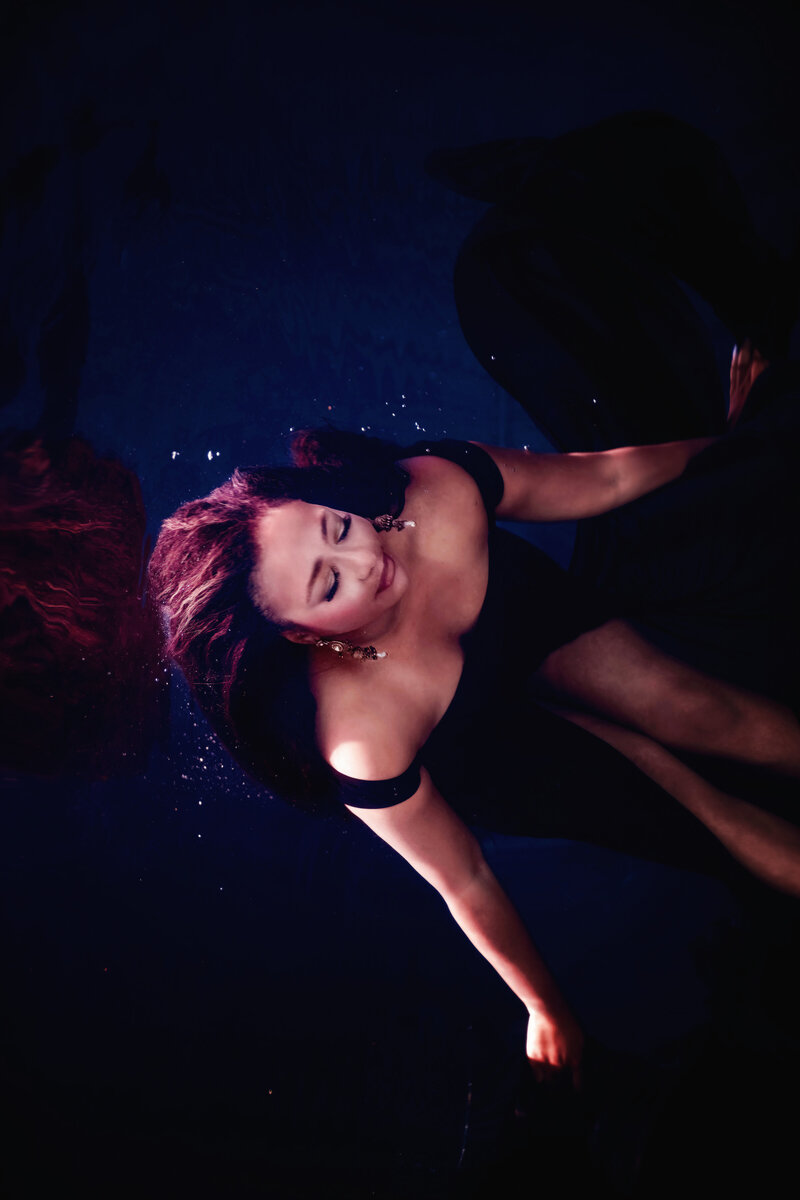 Underwater photo of a woman with bright hair and dress