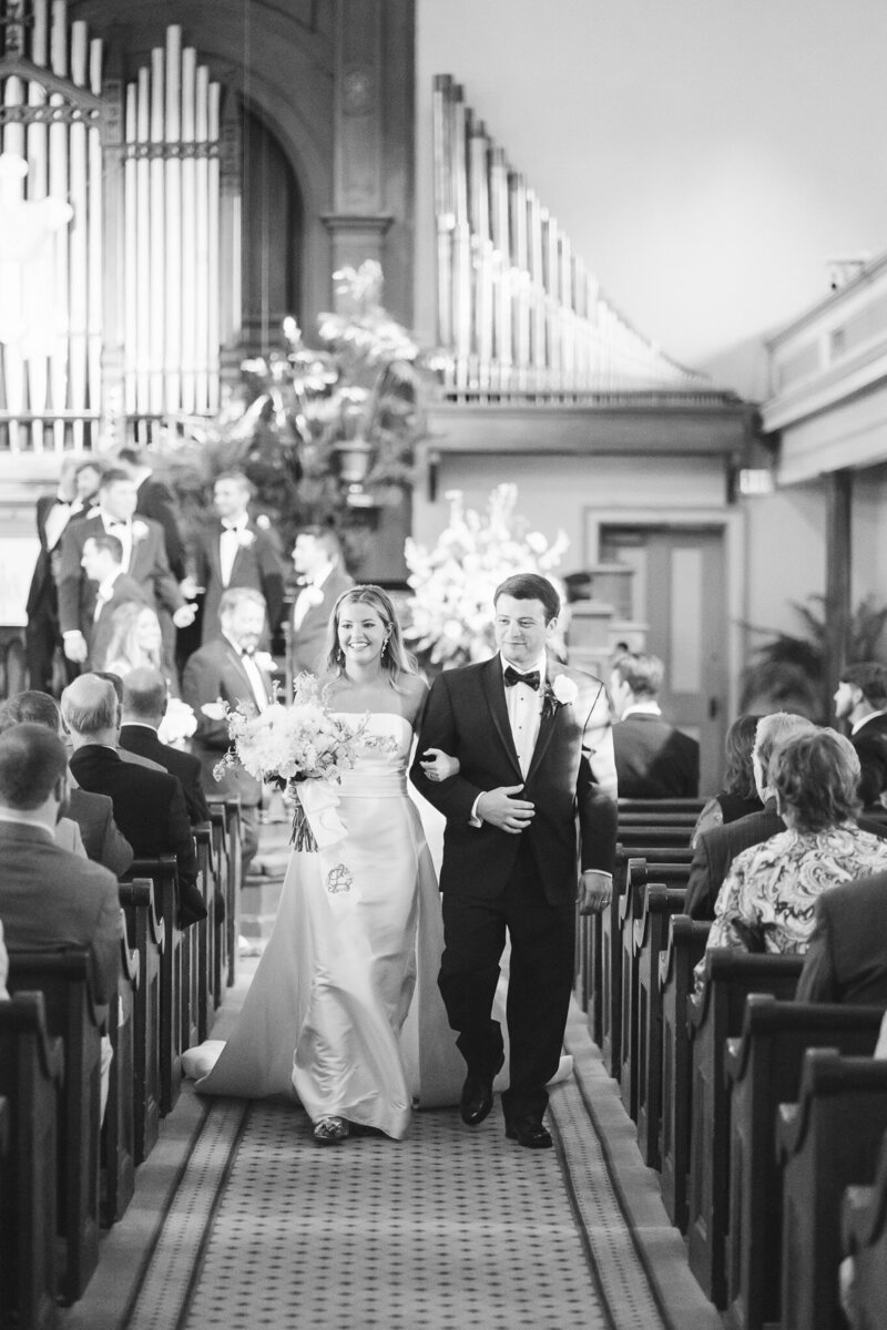 Bride and groom walking down the aisle as husband and wife