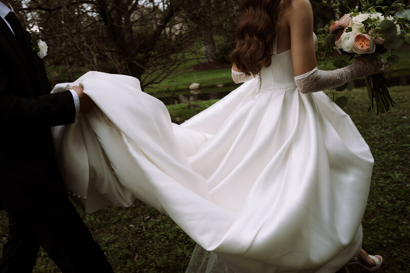 young bride taking photo of groom using 32mm film disposable camera, holding coke bottles