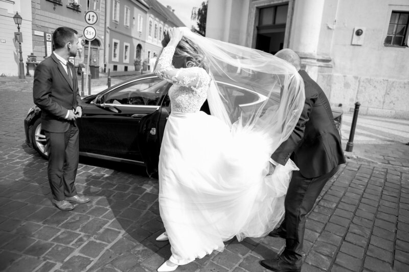 Bride spinning in lace gown on cobblestone street – candid destination wedding photography in Palma, Mallorca