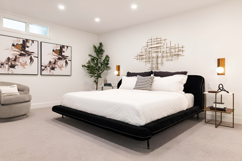 Wide shot of a modern bedroom with a velvet bedframe and unique decor with a fresh hotel-inspired feeling by Sister Studio.