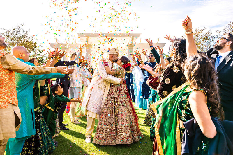 Shannon Lee, an Orlando wedding photographer capturing a magical first dance under sparkling fireworks and twinkling lights, surrounded by guests enjoying the celebration.