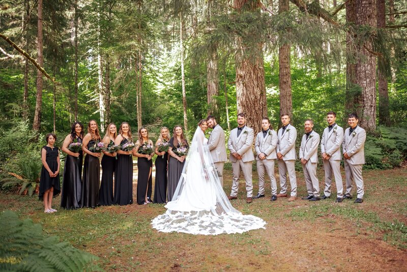 bride and attendants posing in forest while bride wears a custom bridal veil with vintage heirloom lace
