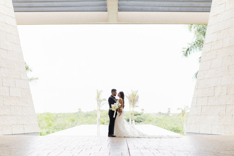 bride and groom in front of palms
