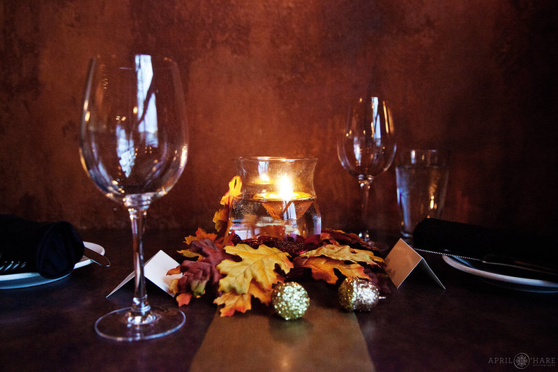 One of the tables set up with simple fall decor for a private wedding reception at the 5th Ave Grill in Frisco Colorado