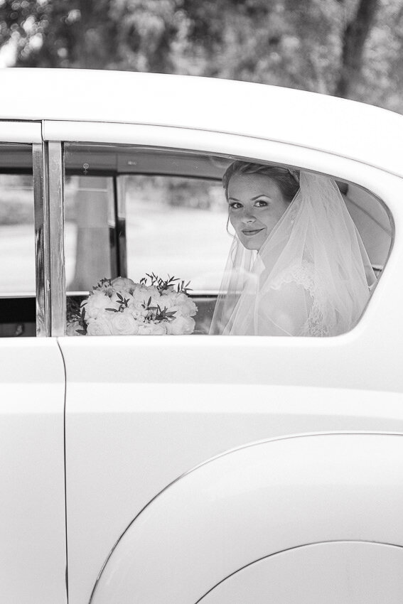 Portrait of the elegant bride in her antique carriage. Montreal wedding photography.