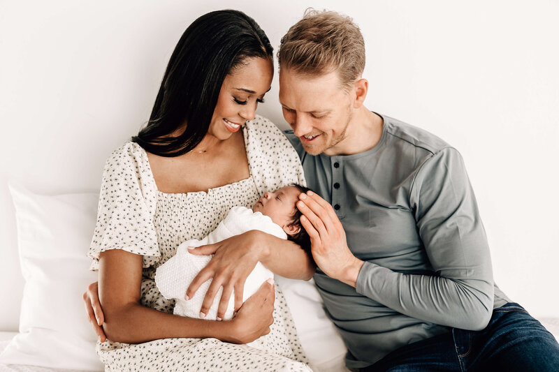New Parents holding newborn baby boy