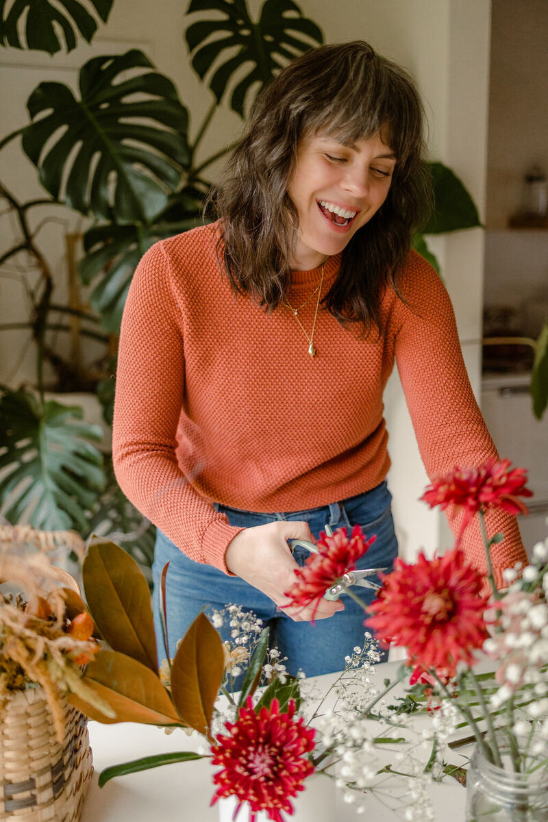 Web designer Carrie Bondioli arranges flowers.