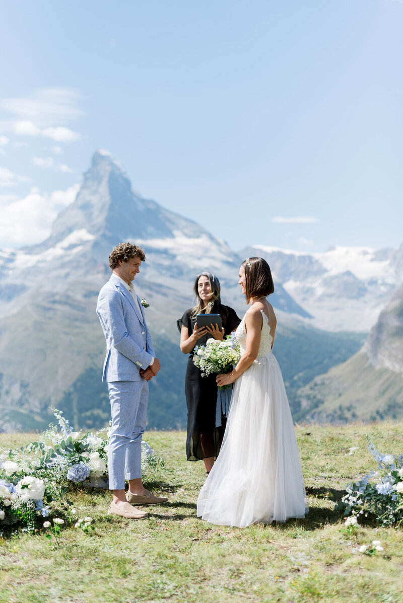 Bride & groom standing in front of the Matterhorn with their officiant during their elopement in Switzerland!
