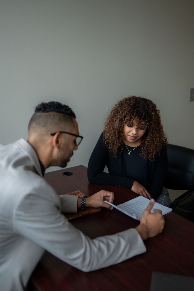 Columbus Ohio Central Ohio family law attorney reviewing prenuptial agreement paperwork with a female client during a consultation before she gets married