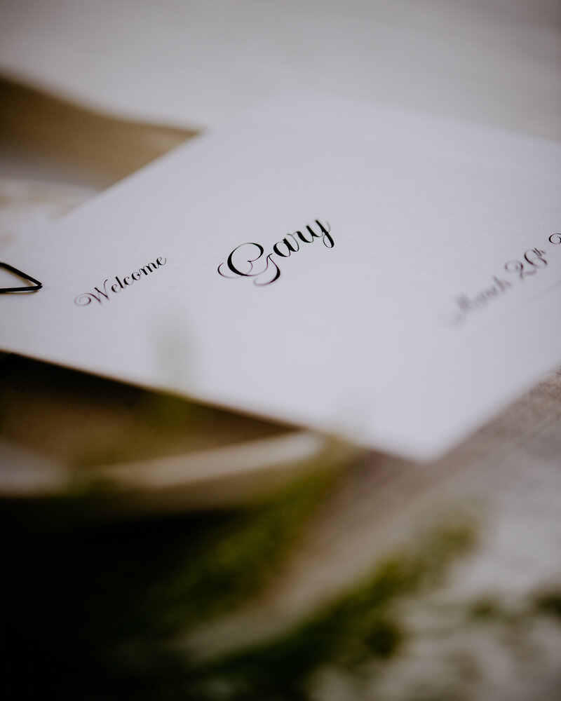 Elegant and contemporary wedding place card with cursive font