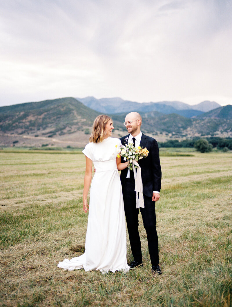 Bride and Groom laughing in Utah Mountains