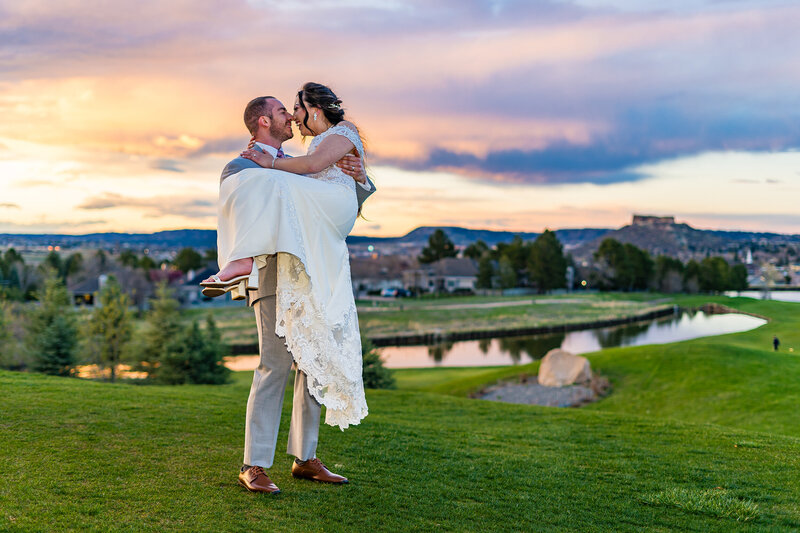 Bride and groom walking at sunset at The Oaks at Plum Creek in Castle Rock, Colorado during their wedding day.