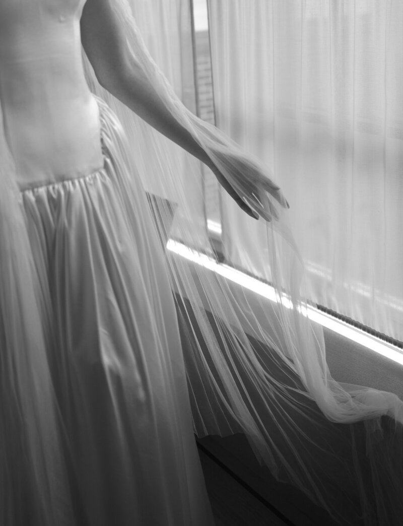 bride's hand feels her transparent, soft pleated veil at Shinola Hotel wedding in Detroit 