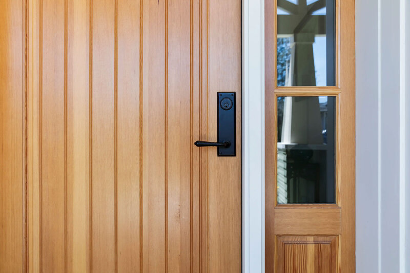 image of a welcoming oak exterior front door with black door hardware