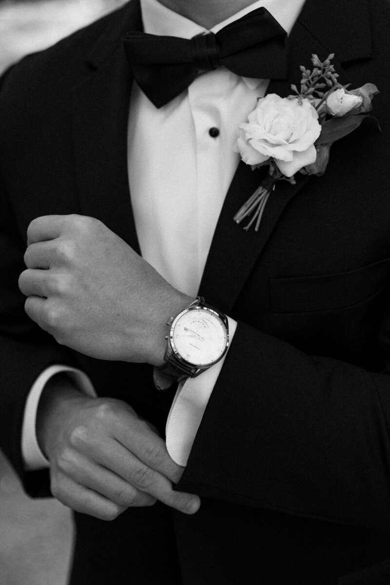 Groom's wedding day details of his tux, inherited watch and boutonniere in Asheville NC, by Andrea-Marie Photography 