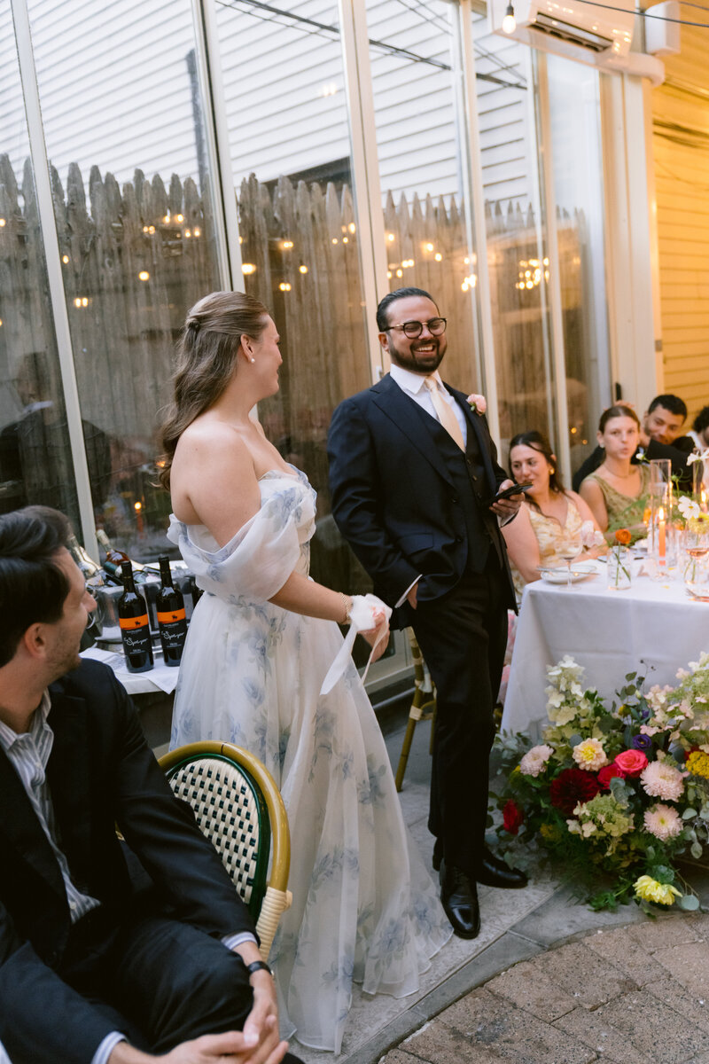 bride and groom holding hands walking with their wedding party behind them