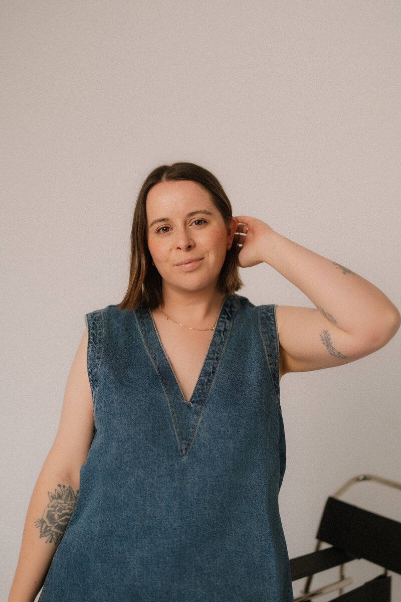 Liv Rollings posing in a denim vest top