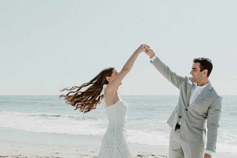 bride and groom dancing on beach at wedding in San Diego