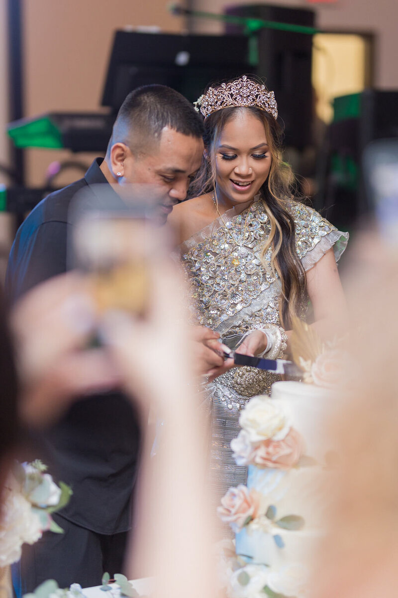 Khmer Bride and groom cutting the cake | Wedding at St. Ephrem Syriac Catholic Church, Jacksonville, FL | Photos by Phavy Photography, Cambodian Wedding Photographer