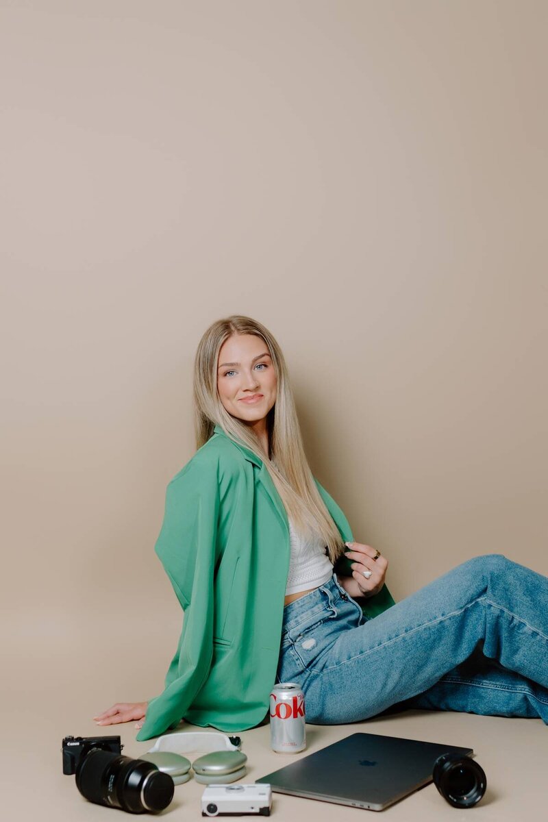 college senior celebrating their graduation with professional photos, white dress